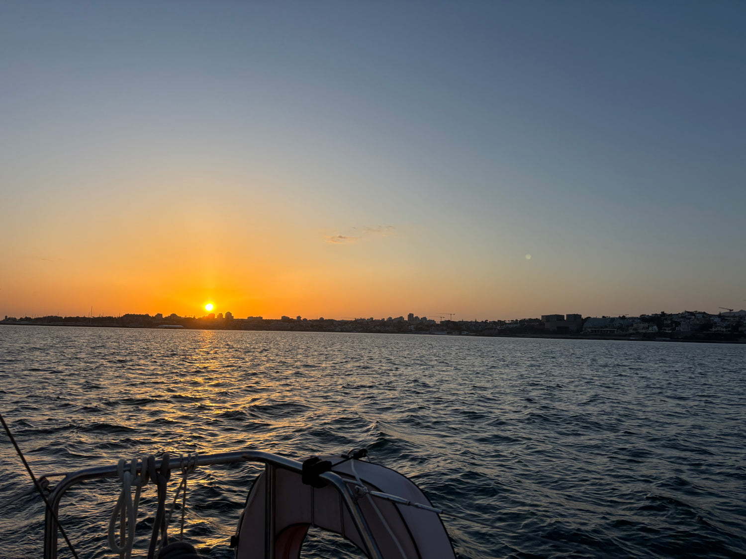 Golden sunset over the Atlantic seen from a sailing yacht off Cascais