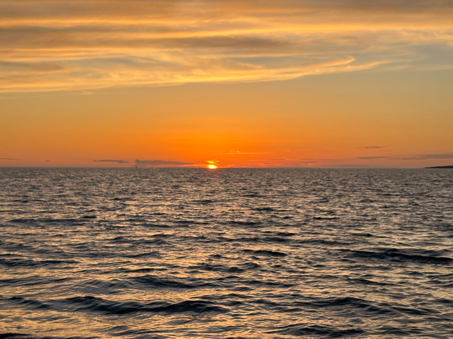 Golden sunset over the Atlantic seen 
from a sailing yacht off Cascais