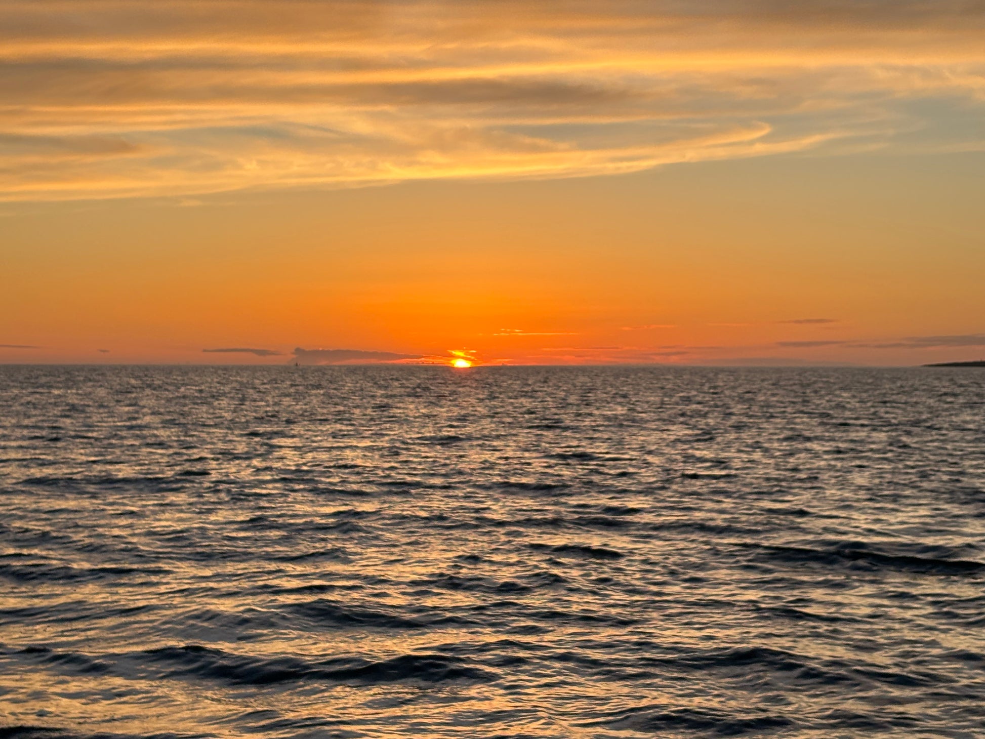 Golden sunset over the Atlantic seen 
from a sailing yacht off Cascais